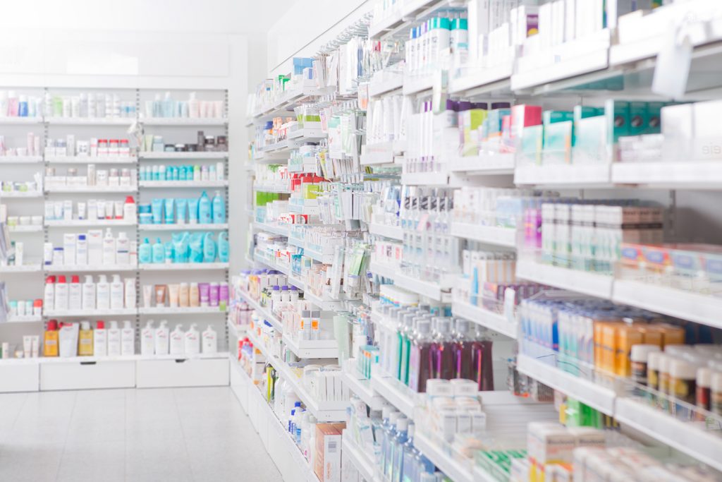 Pharmacy shelves with medications on display.